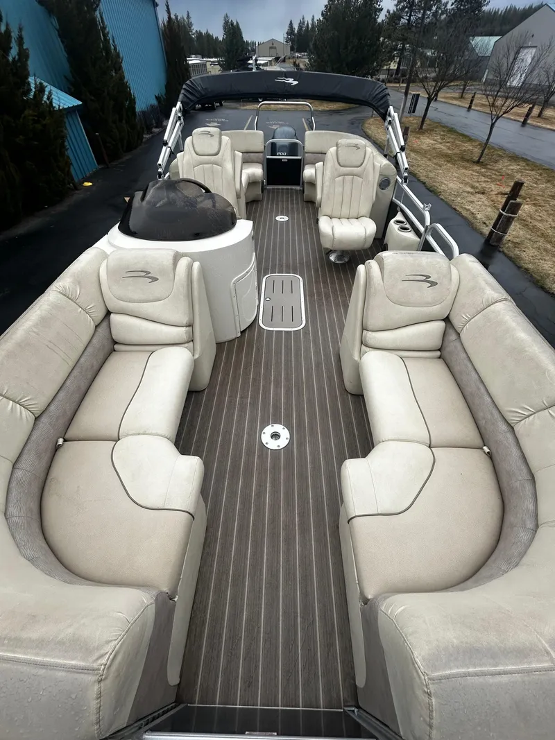 Slide: The Image of 2015 Bennington 2250 GSR pontoon boat with spacious seating and sleek design. - 2