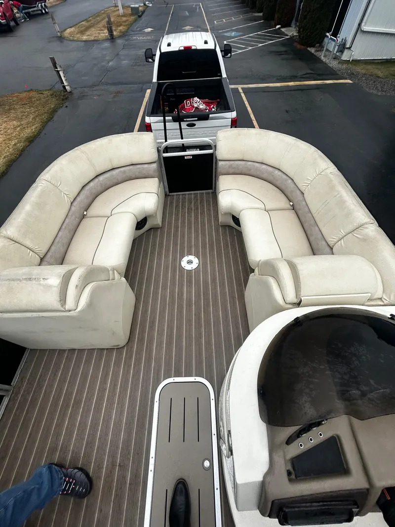 Slide: The Image of 2015 Bennington 2250 GSR pontoon boat with spacious seating, parked on a trailer. - 6