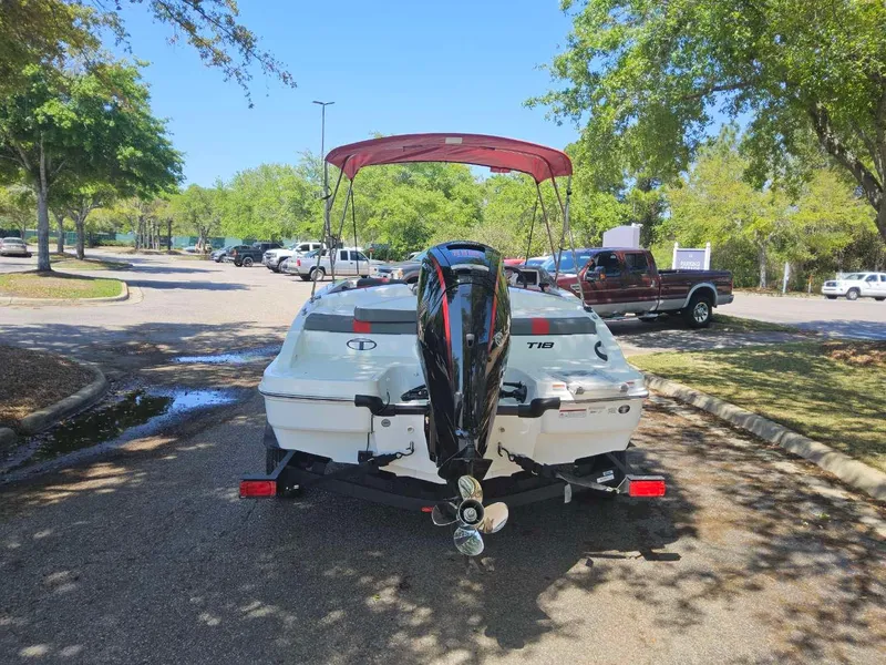 Slide: The Image of 2025 Tahoe T18 boat with outboard motor in a sunny parking lot. - 3