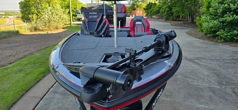 Slide: The Image of 2025 Nitro Z19 boat with trolling motor on a sunny day, parked on a driveway. - 3