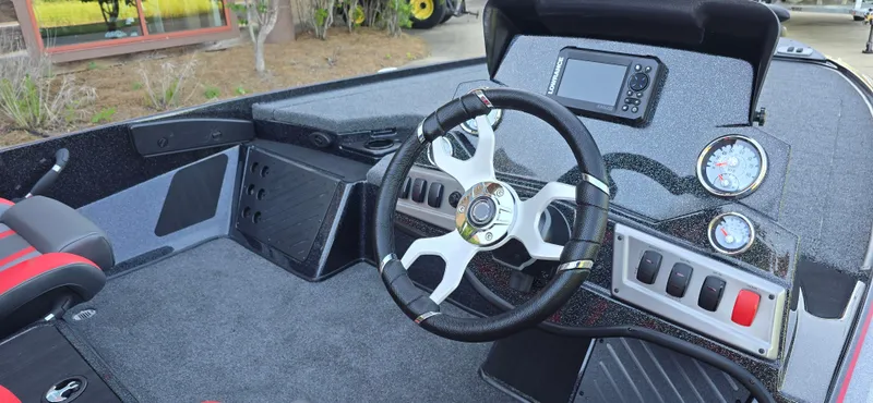 Slide: The Image of 2025 Nitro Z19 boat cockpit with steering wheel, gauges, and control panel. - 5