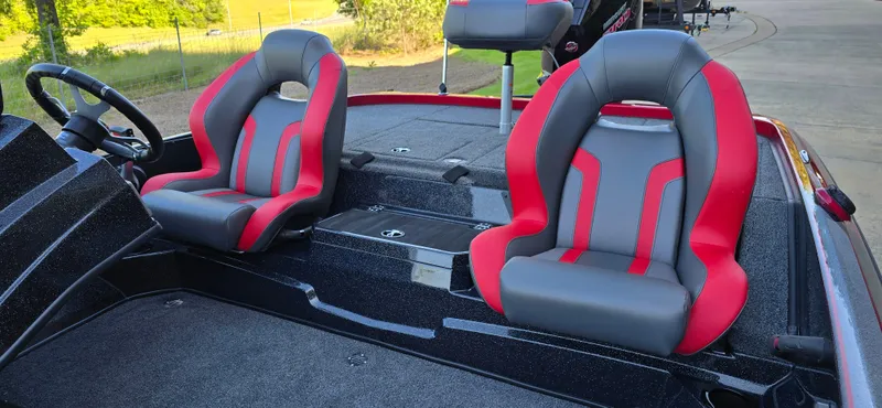 Slide: The Image of 2025 Nitro Z19 boat interior with red and gray seats, steering wheel visible. - 6