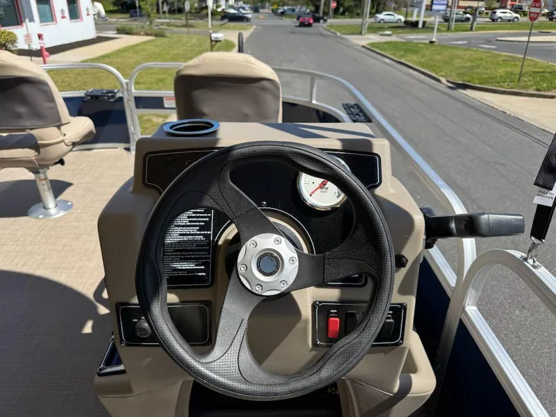 Slide: The Image of 2025 Sun Tracker Bass Buggy 16 XL Select steering console with comfortable seating and road view. - 10