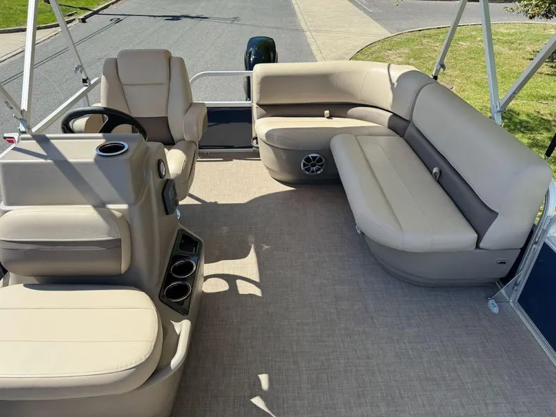 Slide: The Image of 2025 Sun Tracker Bass Buggy 16 XL Select pontoon boat with beige seating and spacious layout. - 11