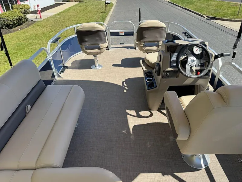 Slide: The Image of 2025 Sun Tracker Bass Buggy 16 XL Select pontoon boat interior with seating and steering console. - 12