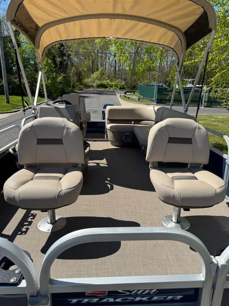 Slide: The Image of 2025 Sun Tracker Bass Buggy 16 XL Select pontoon boat with canopy and seating. - 8