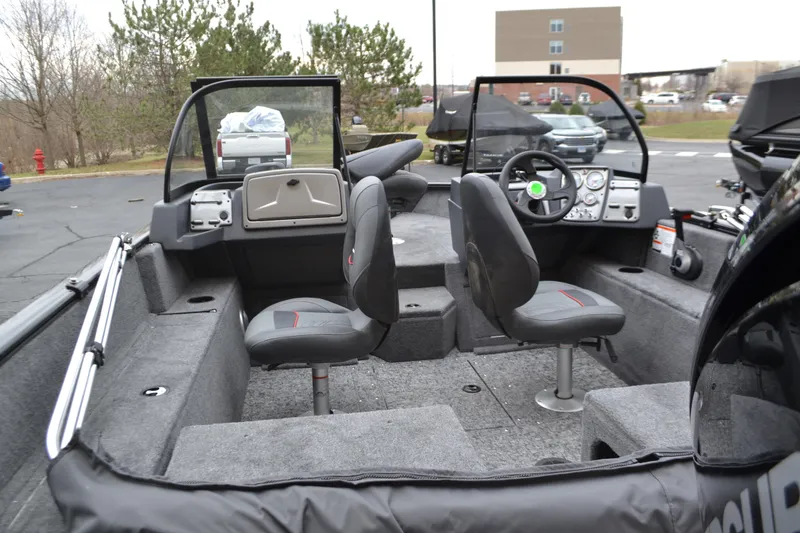 Slide: The Image of 2025 Tracker Pro Guide V-175 Combo boat interior with seating and dashboard. - 2