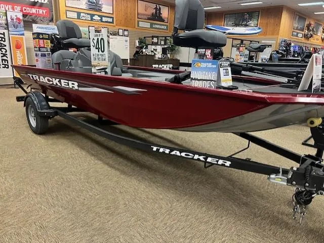 Slide: The Image of 2025 Tracker Pro 170 boat displayed in showroom, red exterior, on trailer. - 2