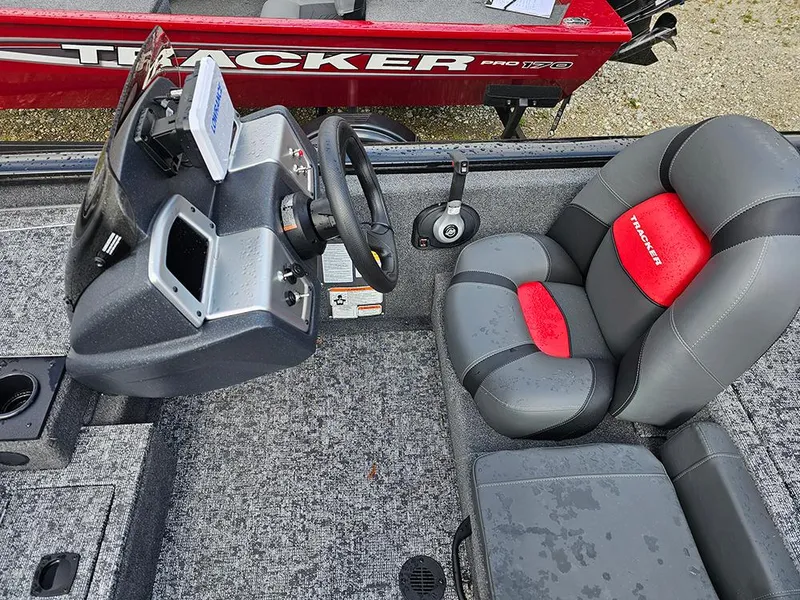 Slide: The Image of 2025 Tracker Pro Team 175 boat interior with steering console and cushioned seat. - 11