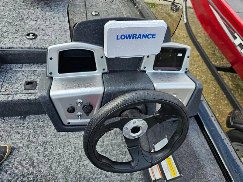 Slide: The Image of 2025 Tracker Pro Team 175 boat dashboard with Lowrance electronics and steering wheel. - 13