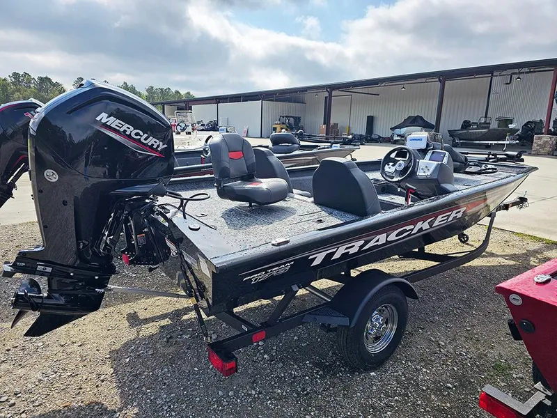 Slide: The Image of 2025 Tracker Pro Team 175 boat with Mercury engine, parked outdoors. - 3