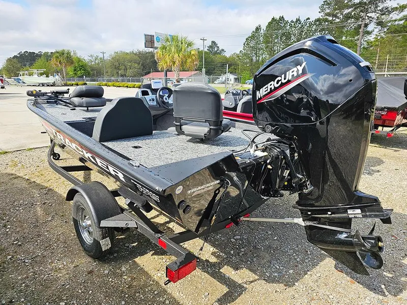 Slide: The Image of 2025 Tracker Pro Team 175 boat with Mercury engine on trailer, parked outdoors. - 5