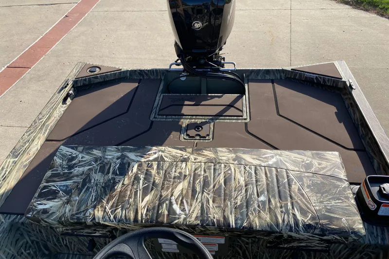 Slide: The Image of 2025 Tracker Grizzly 1860 CC boat with camouflage seating and motor, viewed from above. - 5