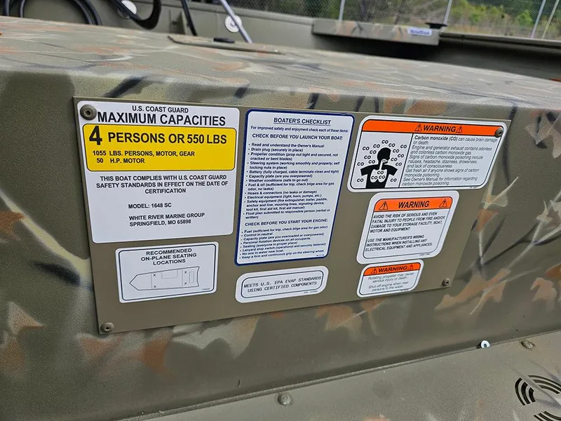 Slide: The Image of 2025 Tracker Grizzly 1648 SC boat capacity and safety warning labels. - 12