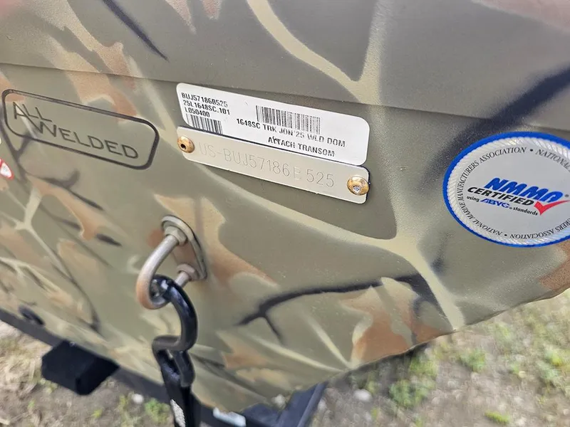 Slide: The Image of 2025 Tracker Grizzly 1648 SC boat with camouflage pattern and certification stickers. - 14