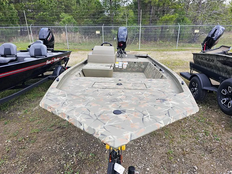 Slide: The Image of 2025 Tracker Grizzly 1648 SC boat with camouflage design, displayed outdoors. - 5