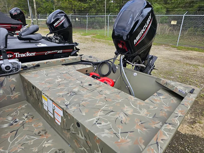 Slide: The Image of 2025 Tracker Grizzly 1648 SC boat with camouflage design and Mercury outboard motor. - 6