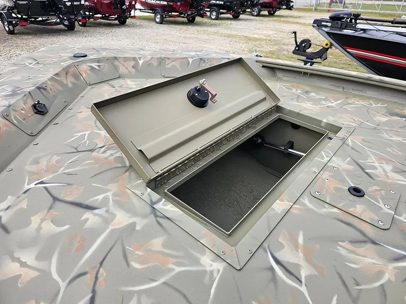 Slide: The Image of 2025 Tracker Grizzly 1648 SC boat with open storage compartment, camo design. - 9
