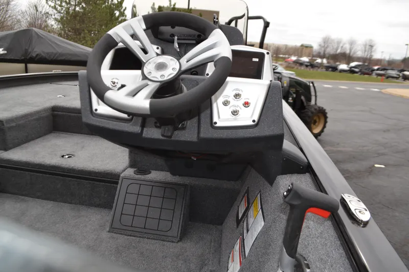 Slide: The Image of Steering console of 2025 Tracker Savage 215 boat, featuring modern controls and design. - 3