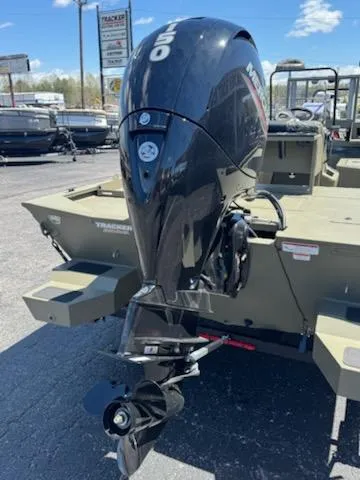 Slide: The Image of 2025 Tracker Grizzly 2072 CC Sportsman boat with powerful outboard motor in a dealership lot. - 3