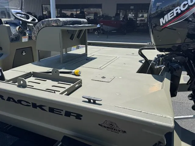 Slide: The Image of 2025 Tracker Grizzly 2072 CC Sportsman boat with Mercury engine, outdoor showroom display. - 5