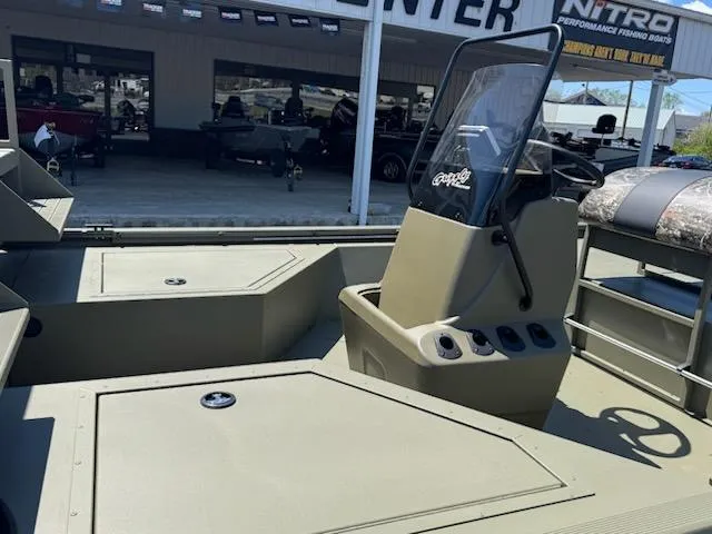 Slide: The Image of 2025 Tracker Grizzly 2072 CC Sportsman boat interior with console and seating. - 6