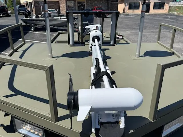 Slide: The Image of 2025 Tracker Grizzly 2072 CC Sportsman boat with mounted equipment, parked outdoors. - 7