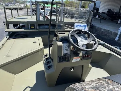 Slide: The Image of 2025 Tracker Grizzly 2072 CC Sportsman boat interior with steering console and Lowrance equipment. - 9