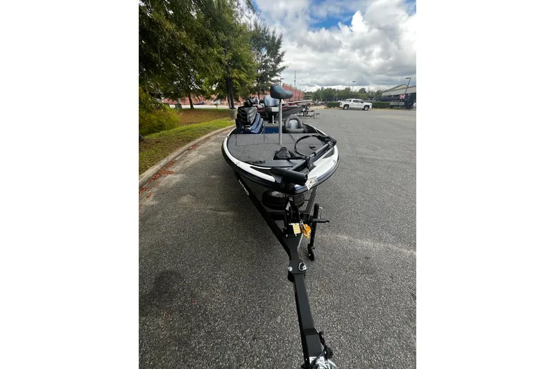 Slide: The Image of 2025 Nitro Z17 boat on trailer, parked on a paved road under cloudy skies. - 5