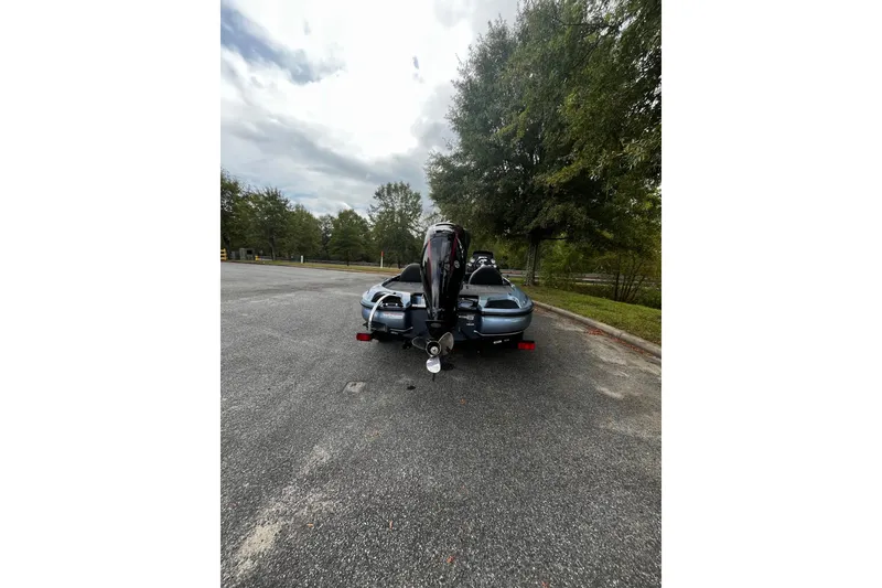 Slide: The Image of 2025 Nitro Z17 boat on trailer in parking lot, surrounded by trees and cloudy sky. - 6