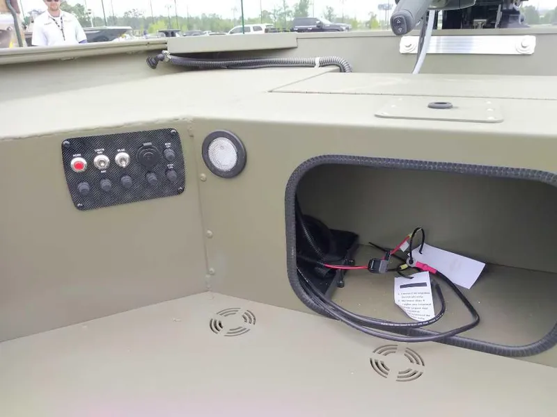 Slide: The Image of Interior view of 2025 Tracker Grizzly 1654 T Sportsman boat with control panel and storage compartment. - 10