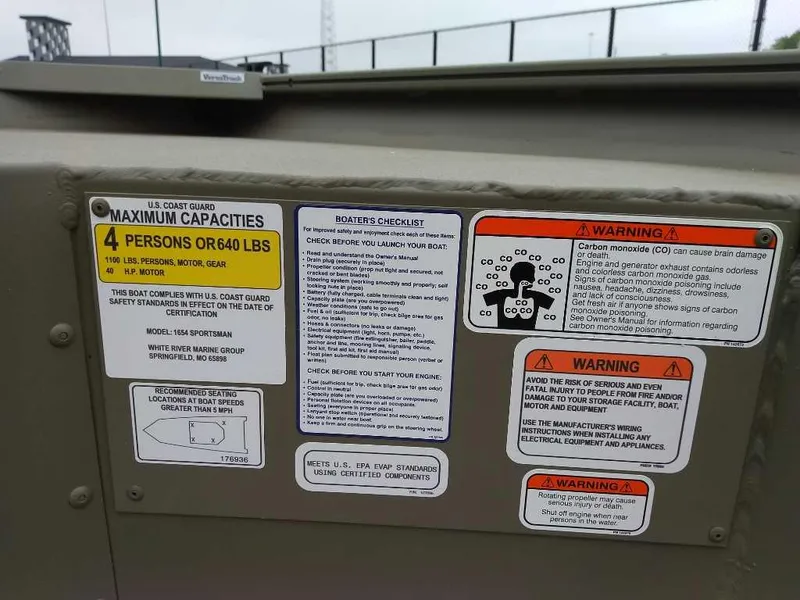 Slide: The Image of 2025 Tracker Grizzly 1654 T Sportsman boat capacity and safety warning labels. - 11