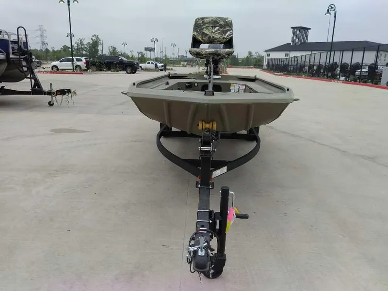 Slide: The Image of 2025 Tracker Grizzly 1654 T Sportsman boat on trailer in outdoor setting. - 2