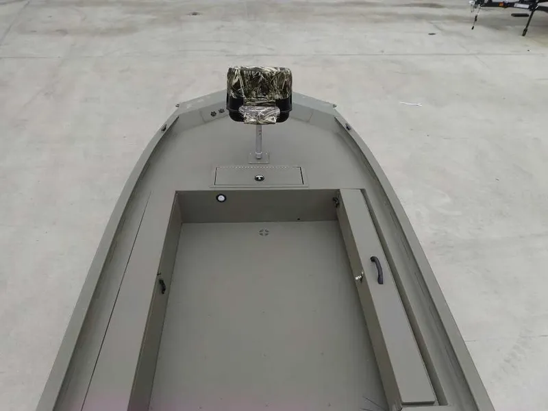 Slide: The Image of 2025 Tracker Grizzly 1654 T Sportsman boat interior with camo seat and storage compartments. - 5