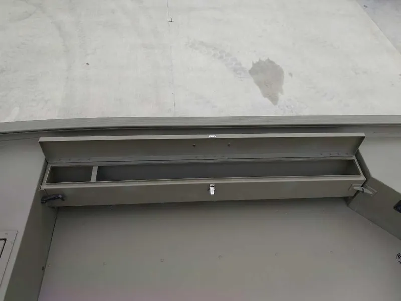 Slide: The Image of Storage compartment of 2025 Tracker Grizzly 1654 T Sportsman boat, open and empty. - 8