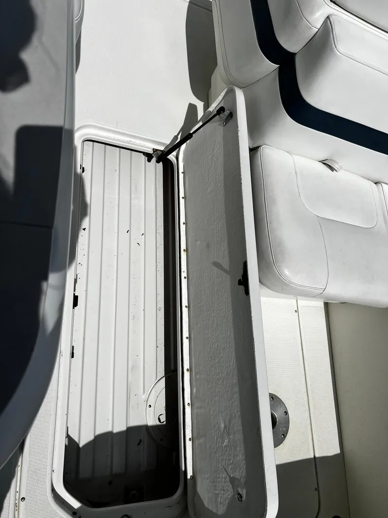 Slide: The Image of Open storage compartment on 2000 Formula 260 Sun Sport boat with white seating. - 15