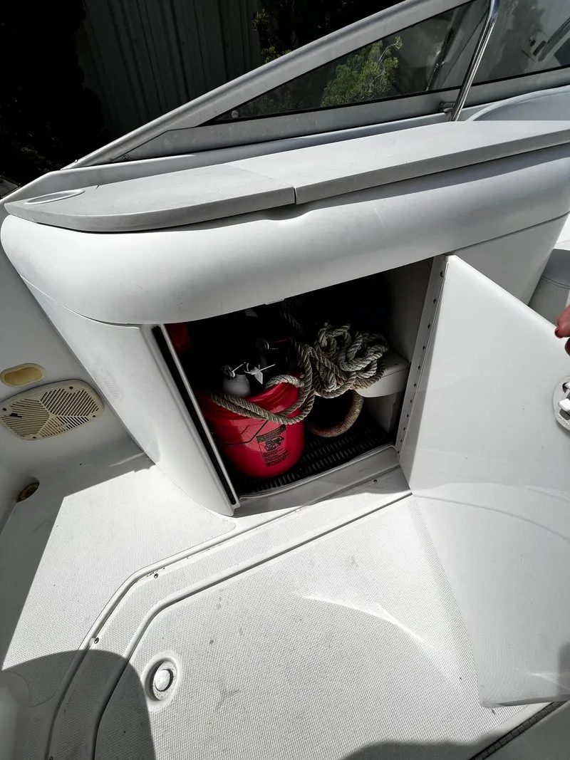 Slide: The Image of Storage compartment on a 2000 Formula 260 Sun Sport boat with ropes and a red container. - 16