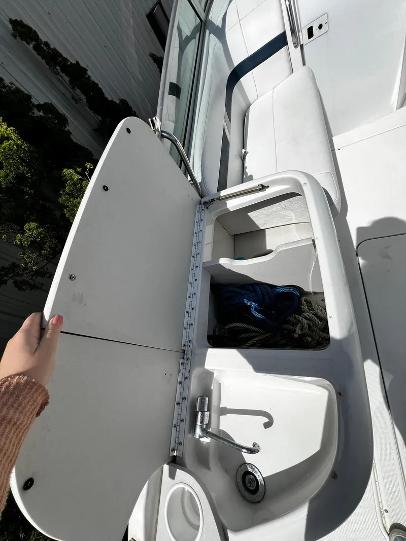 Slide: The Image of 2000 Formula 260 Sun Sport boat interior with open storage compartment and sink. - 17