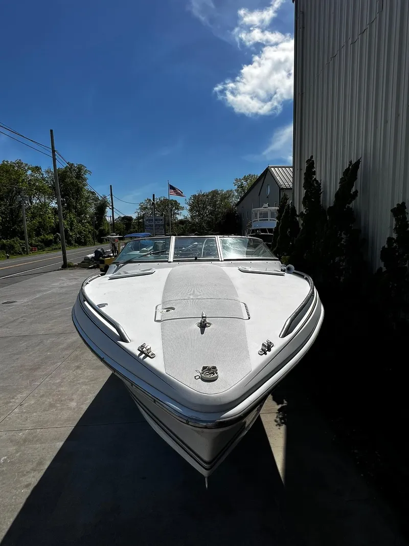 Slide: The Image of 2000 Formula 260 Sun Sport boat parked outdoors under a clear blue sky. - 9