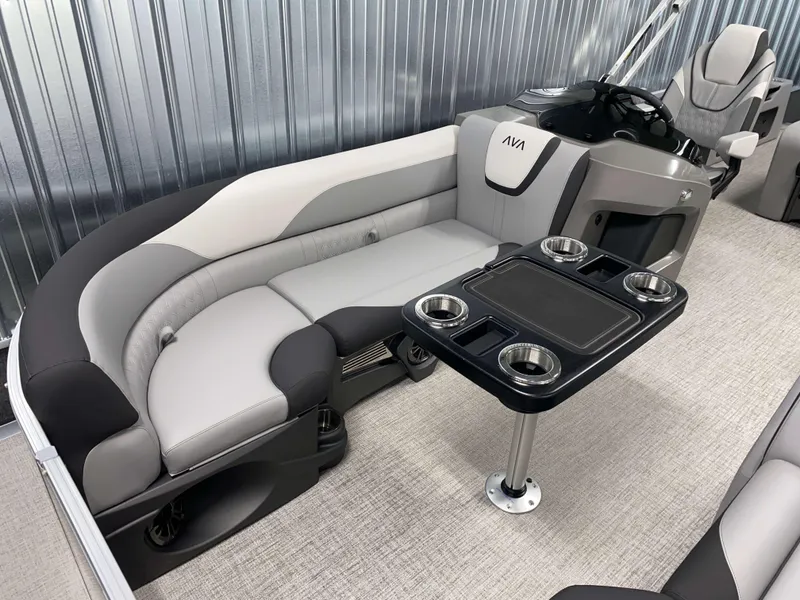 Slide: The Image of 2025 Avalon LSZ 2385 VRB Tritoon interior with plush seating and cupholder table. - 13