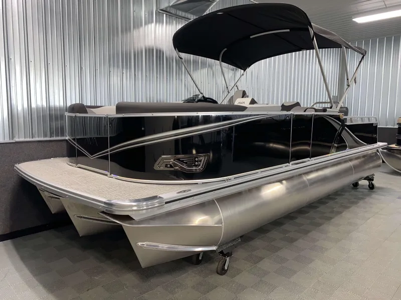 Slide: The Image of 2025 Avalon LSZ 2385 VRB Tritoon boat with sleek black design in a showroom. - 14