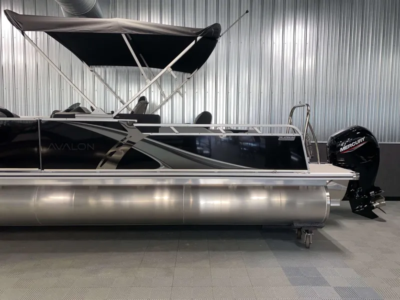 Slide: The Image of 2025 Avalon LSZ 2385 VRB Tritoon boat with Mercury outboard motor in showroom. - 19