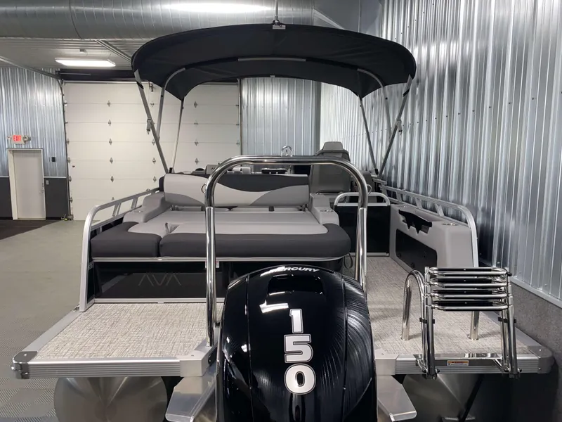 Slide: The Image of 2025 Avalon LSZ 2385 VRB Tritoon with 150 HP engine in a metallic garage. - 20