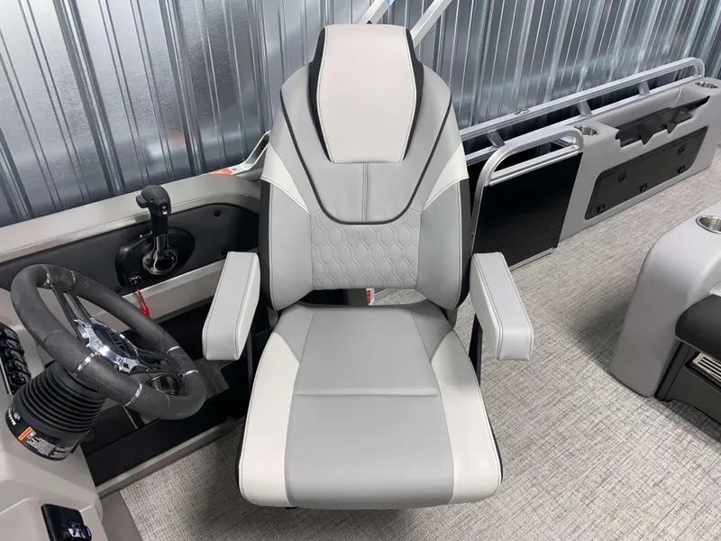 Slide: The Image of Captain's chair in 2025 Avalon LSZ 2385 VRB Tritoon boat, featuring sleek design and modern controls. - 8