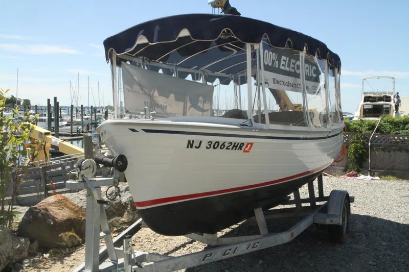 The Image of 2022 Duffy Back Bay 16 electric boat on trailer at marina. - 0