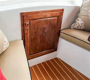 Slide: The Image of Interior of 2022 Duffy Back Bay 16 boat with wooden cabinet and cushioned seating. - 11