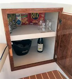 Slide: The Image of Cabinet in 2022 Duffy Back Bay 16 with snacks, glasses, and a wine bottle. - 12