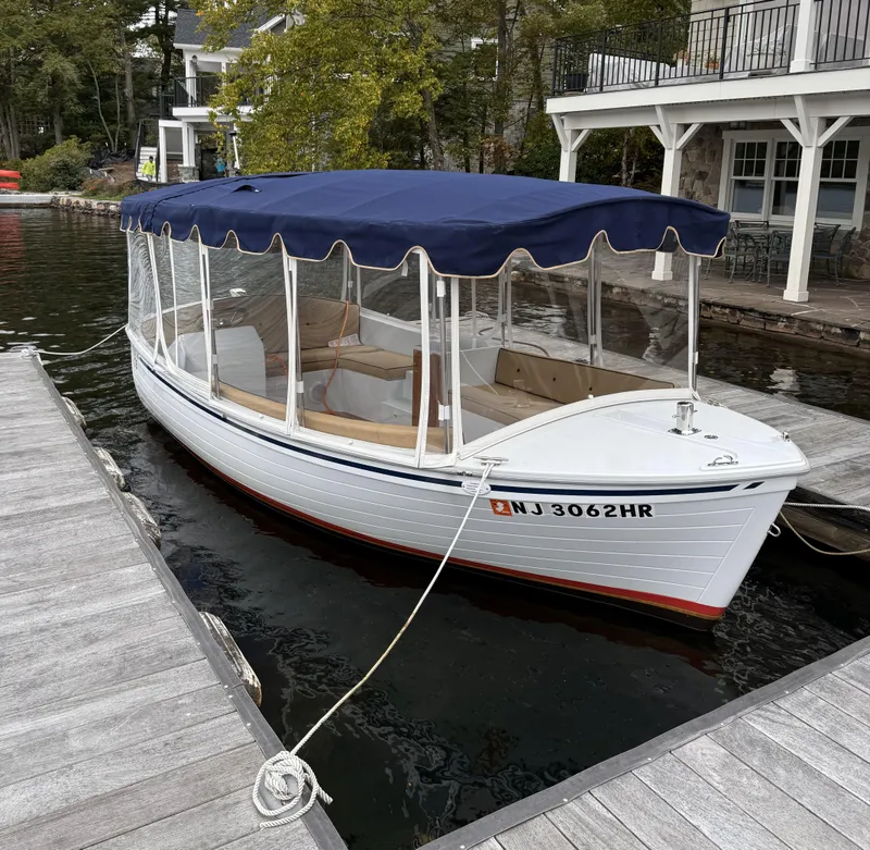 Slide: The Image of 2022 Duffy Back Bay 16 boat docked with blue canopy and clear side panels. - 4