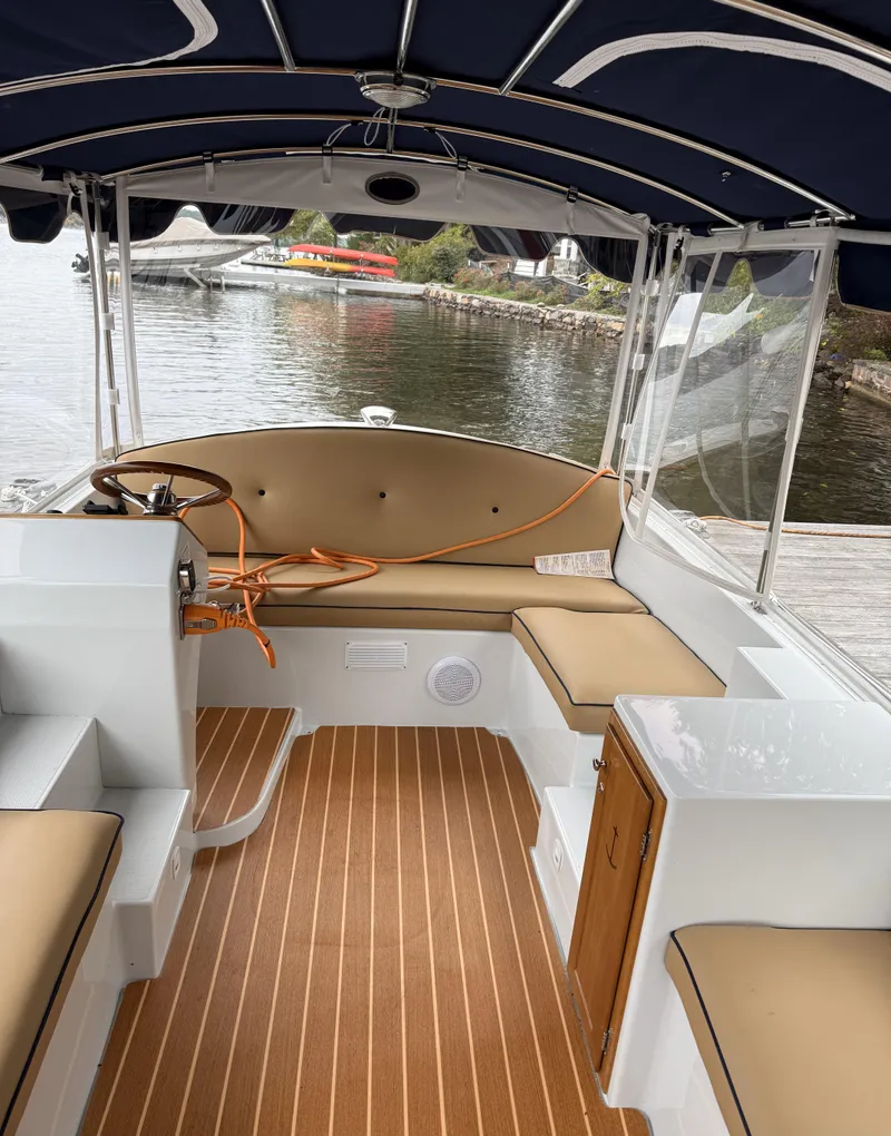 Slide: The Image of 2022 Duffy Back Bay 16 boat interior with tan seating and wood flooring. - 8