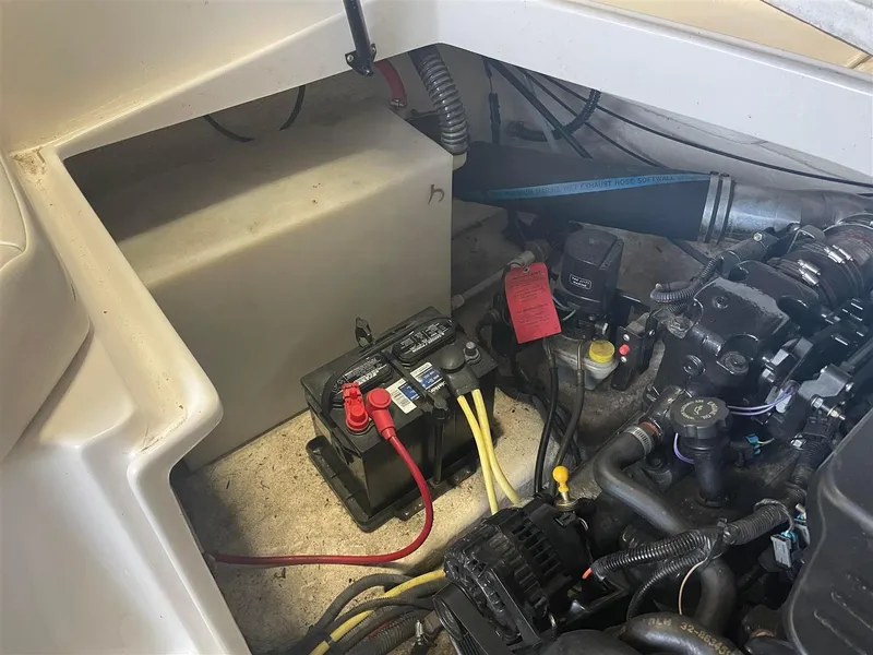Slide: The Image of Engine compartment of a 2003 Chaparral 260 SSi boat, featuring battery and wiring. - 16